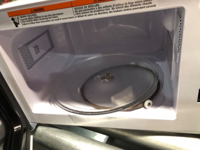 Photo 1 of ***DAMAGED - DENTED - POWERS ON - UNABLE TO TEST FURTHER - SEE PICTURES***
Danby DBMW0721BWW 0.7 cu. ft White Countertop Microwave