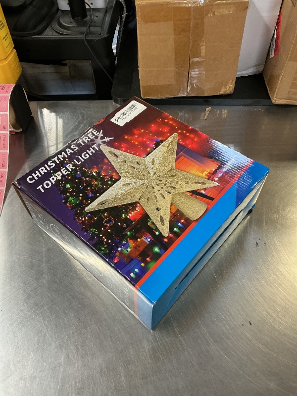 Photo 1 of 10" Christmas Tree Topper Projector with 6 Projection Modes, Lighted Christmas Tree Topper Star Built-in LED Rotation Light, 3D Glitter Dynamic TreeTop for Xmas Holiday Party Decorations Gift (Silver)