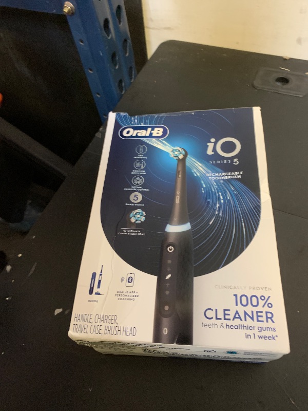 Photo 1 of Oral-B iO Series 5 Rechargeable Electric Toothbrush with Visible Pressure Sensor to Protect Gums, 2 Minute Timer, 5 Cleaning Settings, 1 Replacement Toothbrush Heads, and Travel Case, Black