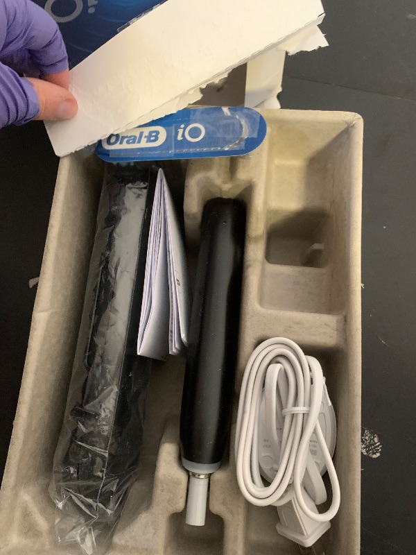 Photo 1 of Oral-B iO Series 5 Rechargeable Electric Toothbrush with Visible Pressure Sensor to Protect Gums, 2 Minute Timer, 5 Cleaning Settings, 1 Replacement Toothbrush Heads, and Travel Case, Black