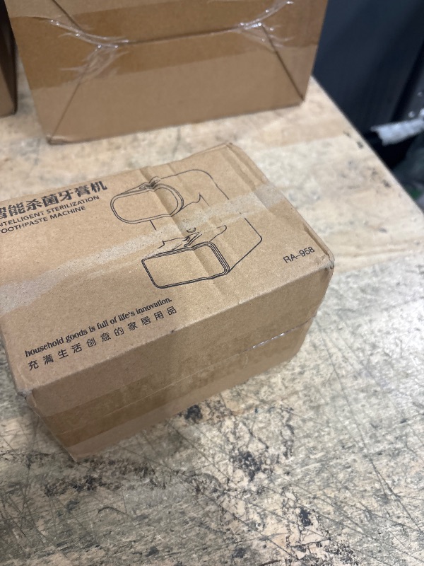 Photo 1 of **USED AND NEEDS CLEANING**Automatic Toothpaste Dispenser, Electric Toothpaste Dispenser Multi-Function, Toothpaste Dispenser Wall Mounted with 3 Brush Slots, Toothbrush Organizer and Holder for Bathroom (Black)