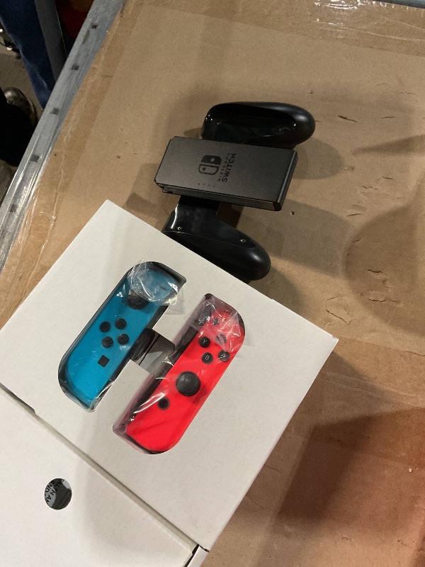 Photo 1 of (used)(incomplete) Nintendo Switch™ with Neon Blue and Neon Red Joy Con™