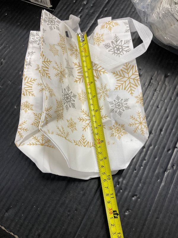 Photo 1 of ***POSSIBLE MISSING PIECES***Lingvee 50 Pcs Winter Snowflake Gift Bag Bulk Gold Sliver Reusable Tote Bags with Handle Xmas Non Woven Candy Bags for Winter Birthday Wonderland Christmas Party Decorations Supplies(Gold Snowflake)***POSSIBLE MISSING PIECES**