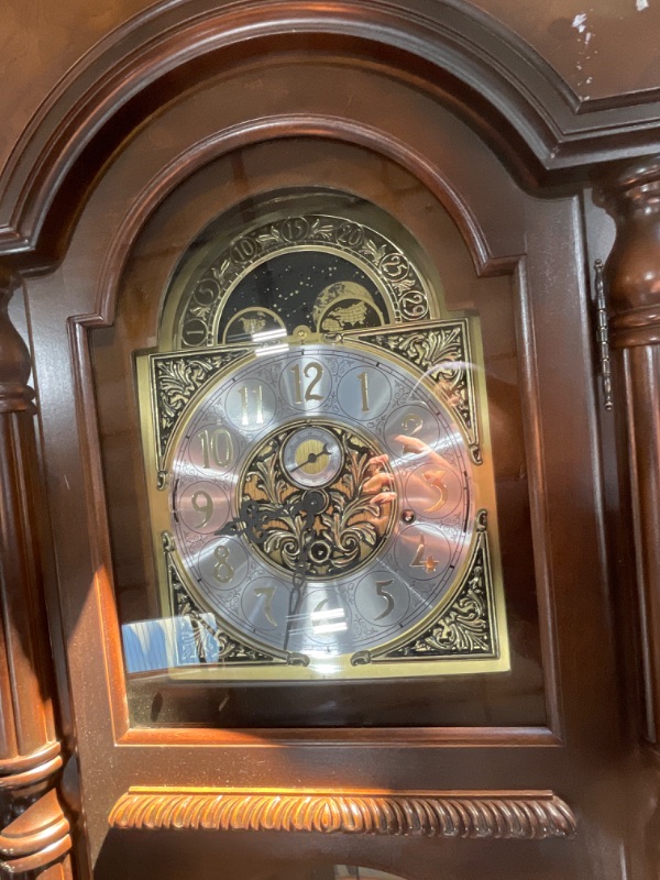 Photo 1 of ***1 BROKEN MIRROR AND MISSING KEY***Howard Miller Vuchinich Grandfather Clock II, Wood Finish with Triple Chime Movement Floor Clocks, Swan-Neck Pediment Perfect for Home Decor, Living Room & Office Heirloom Modern Timepiece
