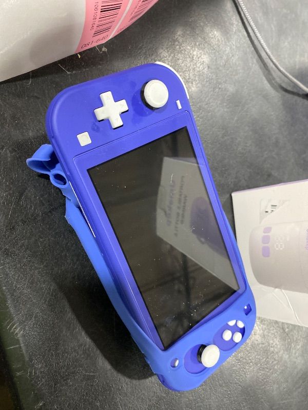 Photo 1 of Nintendo Switch Lite - Blue 
(Charging adapter not included only charging chord)