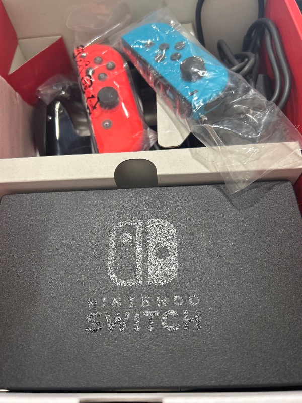 Photo 1 of Nintendo Switch with Neon Blue and Neon Red Joy-Con - Handheld Gaming Console