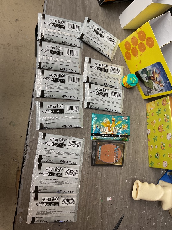 Photo 1 of Magic: The Gathering - Final Fantasy Chocobo Bundle (1 Chocobo Booster, 10 Play Boosters, 1 Alt-Art Promo Card, 1 Scene Card, 32 Basic Lands, 1 Click Wheel, and More)