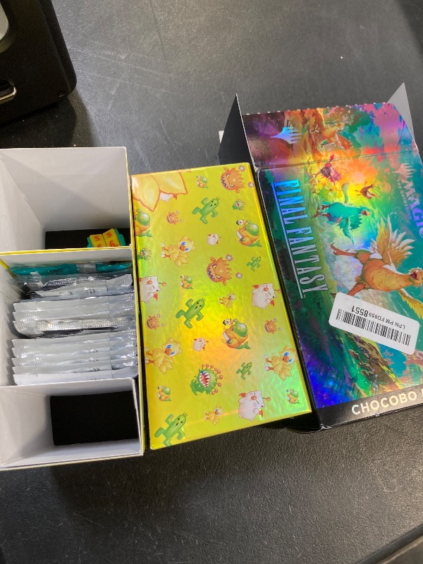 Photo 1 of Magic: The Gathering - Final Fantasy Chocobo Bundle (1 Chocobo Booster, 10 Play Boosters, 1 Alt-Art Promo Card, 1 Scene Card, 32 Basic Lands, 1 Click Wheel, and More)