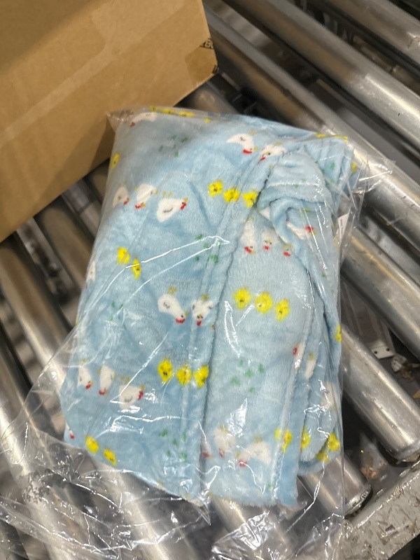 Photo 1 of  Light Blue Blanket with a chicken pattern.