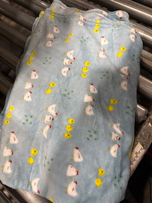Photo 1 of  Light Blue Blanket with a chicken pattern.