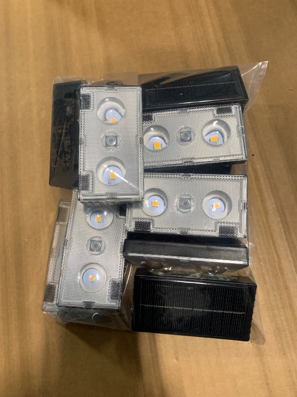 Photo 1 of *** VERY USED *** NIORSUN Solar Fence Lights,12 Pack Deck Light,Led Lights Warm White Outdoor Wall Lights,IP45 Solar Powered Light Waterproof for Backyard/Pool/Railing/Patio/Porch/Step/Outside/Garden (Black)