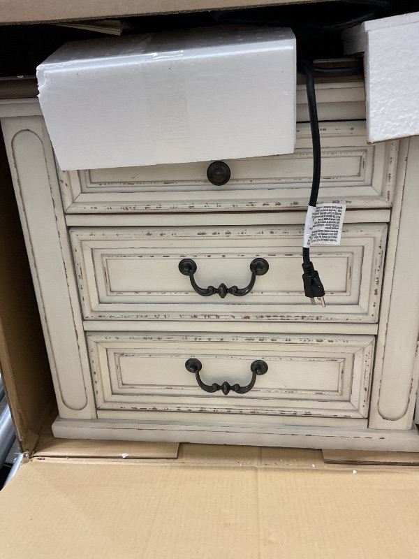 Photo 1 of Signature Design by Ashley Realyn French Country 3 Drawer Nightstand with Electrical Outlets & USB Ports, 27.75" Tall, Chipped White