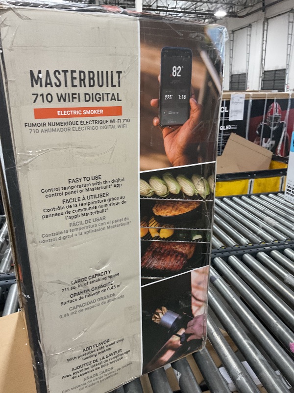 Photo 1 of Masterbuilt®710 WiFi Digital Smoker, Vertical Design, 711 Cooking Sq. Inches, 4 Chrome Coated Smoking Racks, Wood Chip Loader, Electric Fuel Source to Plug in and Start Cooking, Black Model MB20070924