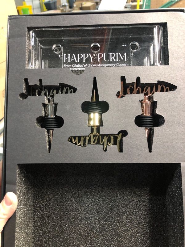 Photo 1 of ***STOCK PHOTO FOR REFERENCE ONLY***
Happy Purim L Chaim Wine Stopper Set with holder