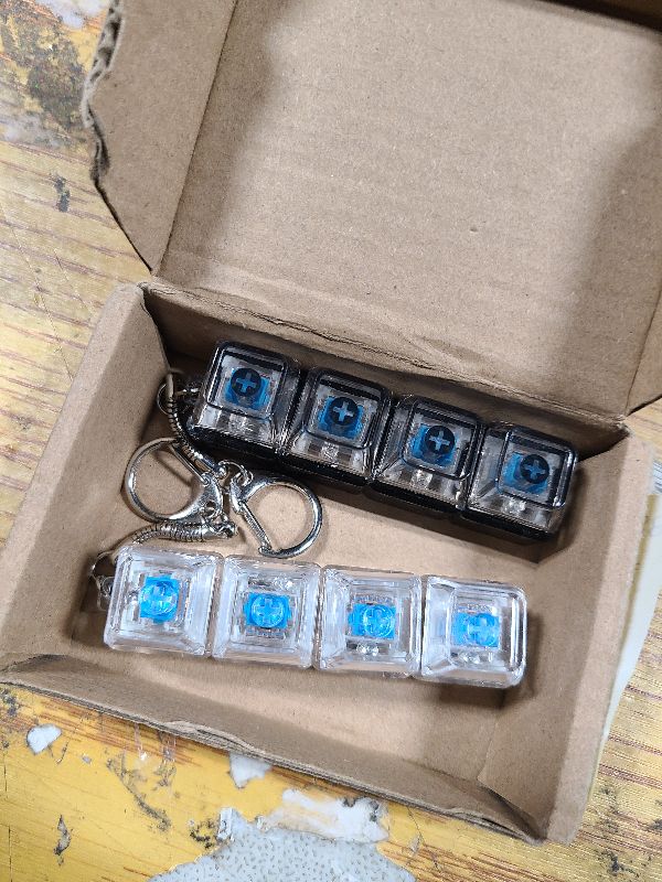 Photo 1 of 2 Pcs Keyboard Fidget Toy for Adults Fidget Keyboard Clicker Toys with LED Lights Keychain Stress Relief for Anxiety Decompression (Black and White)