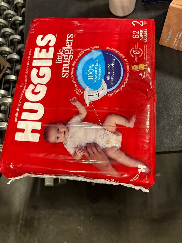 Photo 1 of **62 diapers**
Huggies Size 2 Diapers, Little Snugglers Baby Diapers, Size 2 (12-18 lbs), 186 Count (3 Packs of 62), Packaging May Vary