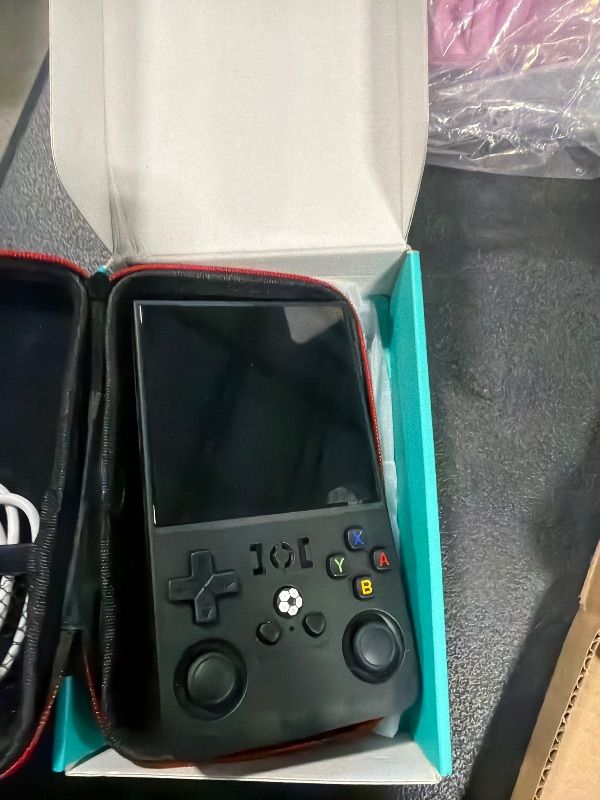 Photo 1 of ?R36MAX 4000mAh Portable Rechargeable Handheld Retro Game Console,Comfort Non-Slip Handheld Standing Retro Game Console with 64G TF Car,4.0-inch Screen,for Office,Black
