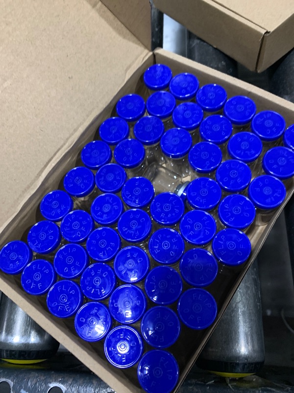 View 1 of small glass containers with flip off lids 
count unknown