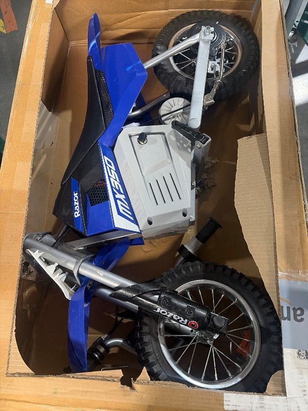 Photo 1 of ***MISSING PARTS & CHARGER***
 Razor MX350 Dirt Rocket Electric Bike for Kids Ages 8+, 140 lb Max Weight, Blue – 24V Battery, Up to 14 Mph, 30-Min Ride Time on High Speed, Twist-Grip Throttle, Spoked Wheels w/ 12” Pneumatic Tires