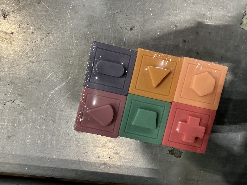 Photo 1 of  a set of soft, silicone sensory stacking blocks designed for infants and toddlers
