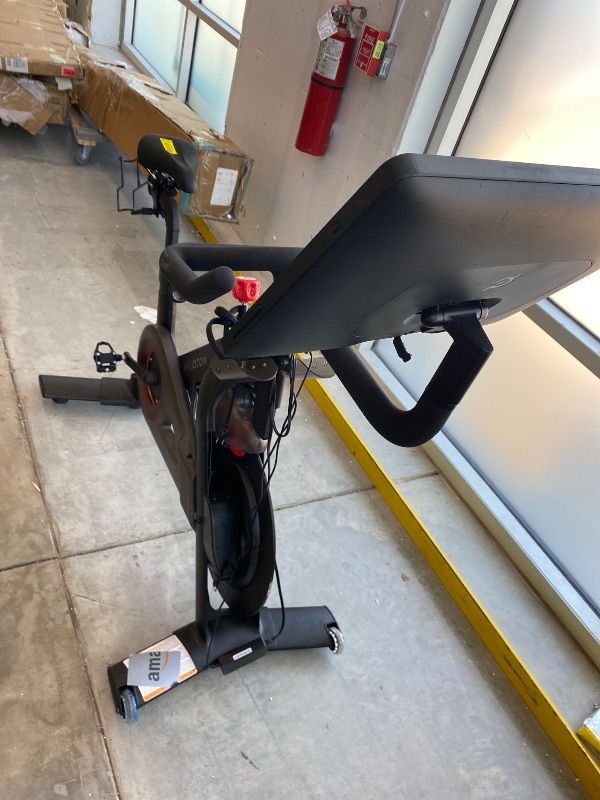 Photo 1 of *NON-FUNCTIONAL*
Peloton Exercise Cross Training Bike, Indoor Stationary Spin Bike for Home Workouts, Space-Friendly Exercise Equipment for Cardio and strength Workout & Indoor Cycling