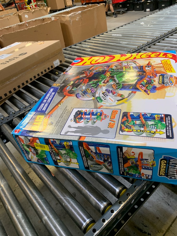 Photo 1 of Hot Wheels Ultimate Garage Track Set with 2 Toy Cars, Hot Wheels City Playset with Multi-Level Side-by-Side Racetrack, Moving T-Rex Dino & Storage for 100+ 1:64 Scale Vehicles (Amazon Exclusive)
