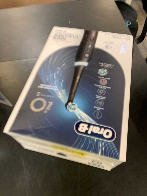 Photo 1 of Oral-B iO Series 5 Rechargeable Electric Toothbrush with Visible Pressure Sensor to Protect Gums, 2 Minute Timer, 5 Cleaning Settings, 1 Replacement Toothbrush Heads, and Travel Case, Black