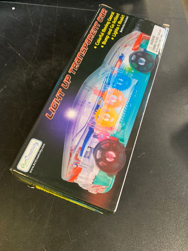 Photo 1 of ArtCreativity Light Up Transparent Sensory Car Toy for Kids, 1PC, Bump and Go Toy Car with Colorful Moving Gears, Music, and LED Effects, Easter Toys for Toddlers, Great Birthday Gift Idea
