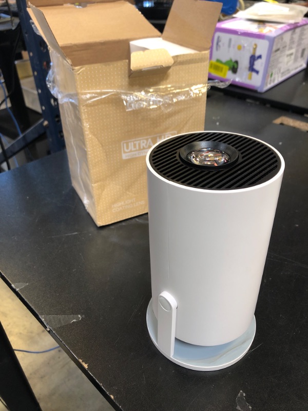 Photo 1 of Mini Projector with WiFi and Bluetooth Built-in Apps Smart Projector Support 4K 1080P FHD 180° Adjustable Auto Keystone Compatibile with HDMI/TV Stick/Memory Stick/Laptop, White