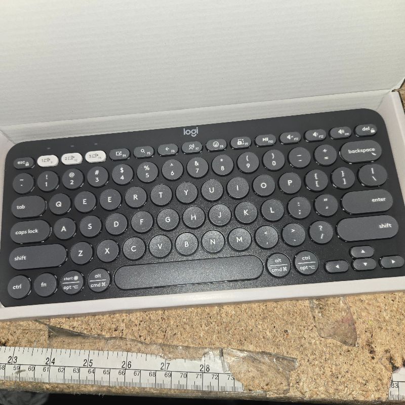 Photo 1 of **Two Es** Logitech Pebble Keys 2 K380s, Multi-Device Bluetooth Wireless Keyboard with Customizable Shortcuts, Slim and Portable, Easy-Switch for Windows, macOS, iPadOS, Android, Chrome OS - Tonal Graphite