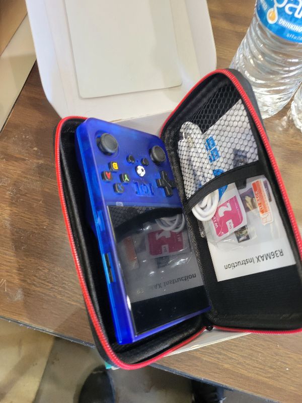 Photo 1 of ?R36MAX 4000mAh Portable Rechargeable Handheld Retro Game Console,Comfort Non-Slip Handheld Standing Retro Game Console with 64G TF Car,4.0-inch Screen,for Office,Blue