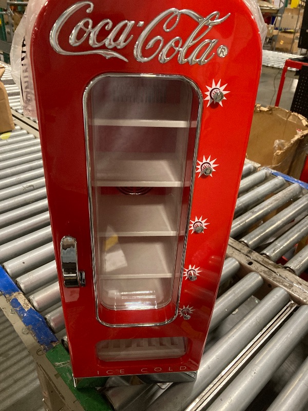 Photo 1 of *MAJOR DAMAGE*
Coca-Cola AC/DC Retro Vending Electric Cooler with 10 Can Capacity - Beverage Vending Machine with Thermoelectric Cooling and Tall Window Display