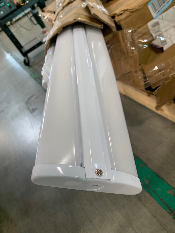 Photo 1 of  ***ONE IS HEAVILY DAMAGED, OTHER LIGHT IS SLIGHTLY BENT, SELLING AS IS FOR PARTS, FINAL SALE***hykolity 110W 8FT LED Shop Lights Ultra Slim LED Wraparound, 12600lm 5000K LED Strip Lights, 8 Foot Flush Mount Warehouse Garage Office Ceiling Light Fixture, 