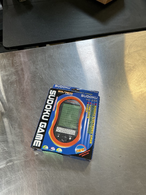 Photo 1 of Bits and Pieces Handheld Sudoku Game, Electronic Pocket Size Sudoku Game with LED Screen, Measures 2-3/4 in. Wide x 4-3/4 in. Long x 3/4 in. Deep