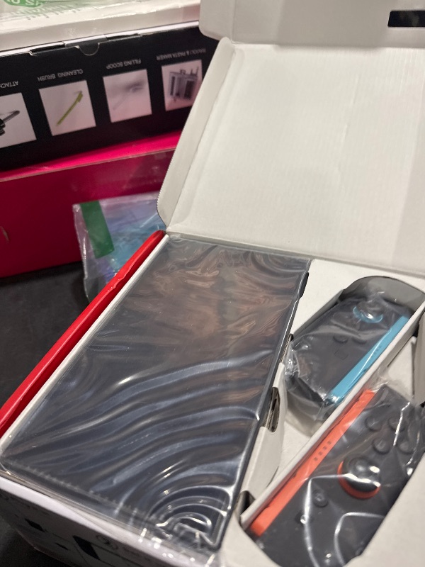 Photo 1 of Nintendo Switch with Neon Blue and Neon Red Joy-Con - Handheld Gaming Console