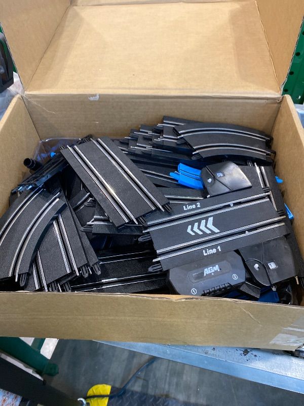 Photo 1 of *MISSING PARTS*
AGM MASETCH High Speed Series Tram Dual Track Set, Track with 4 Vehicles Official Licensed Slot car Racing, Comes with 2 Hand Controls and Track Parts and a Lap Counter.