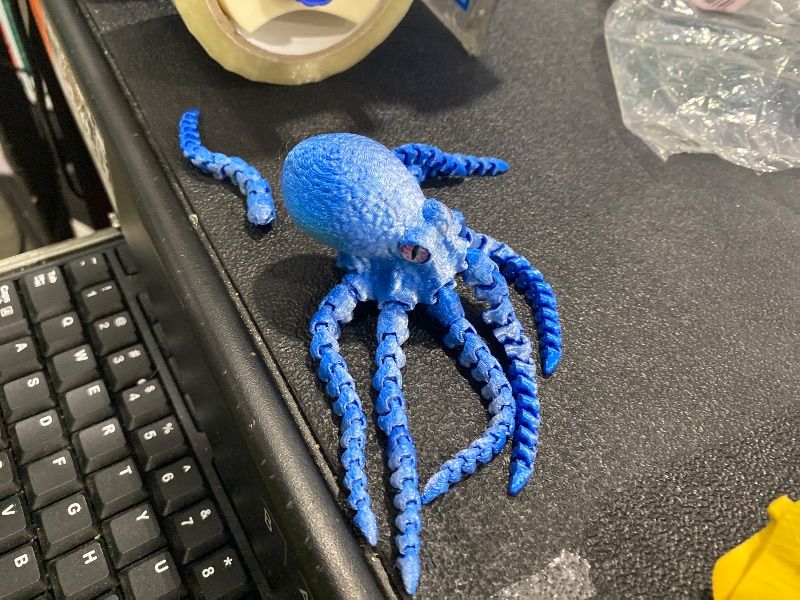 Photo 1 of ***ONE BROKEN LEG*** ATESSON 3D Printed Octopus,3D Printed Animals,3D Printed Toys Flexible Joints 3D Octopus,Home Office Classroom Decor Executive Desk Fidget Toys,1 Piece (Blue Silver)