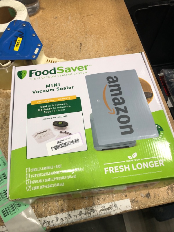 Photo 1 of ***MISSING STORAGE BAG**** FoodSaver Mini Handheld Vacuum Sealer Machine with Marinate Setting & Charging Dock | Cordless Food Vacuum Sealer for Freezer, Storage, Sous Vide, Meal Prep | Blue