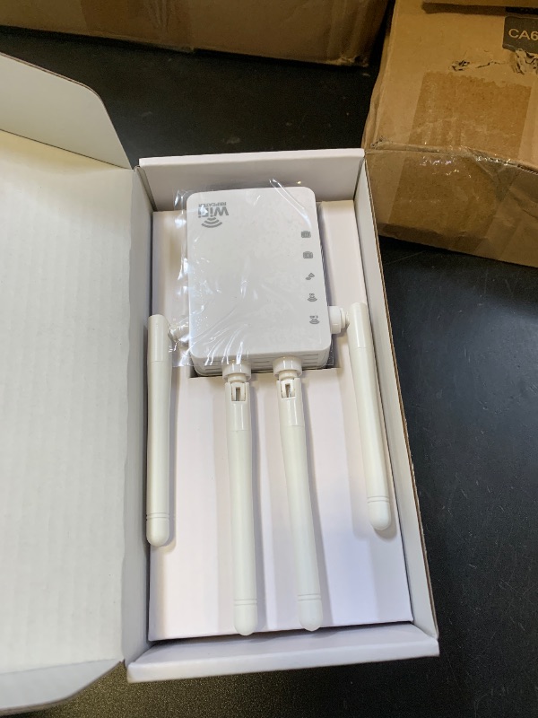 Photo 1 of WiFi Extender Signal Booster,Up to 12880 Sq.ft and 105 Devices, 1200Mbps Dual-Band Speed,1 Ethernet Port,Easy Set up