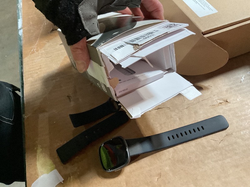Photo 1 of ***FOR PARTS/ NON-FUNCTIONAL /MISSING CHARGER*** Fitbit Versa 4 Fitness Smartwatch with Daily Readiness, GPS, 24/7 Heart Rate, 40+ Exercise Modes, Sleep Tracking and more, Black/Graphite, One Size (S & L Bands Included)