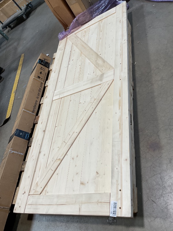 Photo 1 of **DOOR AND BIG METAL PIECE ONLY**SMARTSTANDARD 36in x 84in Sliding Barn Door with 6.6ft Barn Door Hardware Kit Included, Unfinished Solid Spruce Wood Door, Assembly Required, DIY, Stainable, Natural