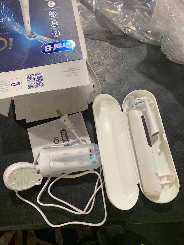 Photo 1 of Oral-B iO Deep Clean + Whiten Rechargeable Electric Toothbrush with Visible Pressure Sensor, 2 Minute Timer, 5 Cleaning Settings, 1 iO5 Limited, 3 Toothbrush Heads, Travel Case & Refill Holder, White