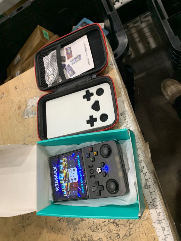 Photo 1 of ?R36MAX 4000mAh Portable Rechargeable Handheld Retro Game Console,Comfort Non-Slip Handheld Standing Retro Game Console with 64G TF Car,4.0-inch Screen,for Office,Black
