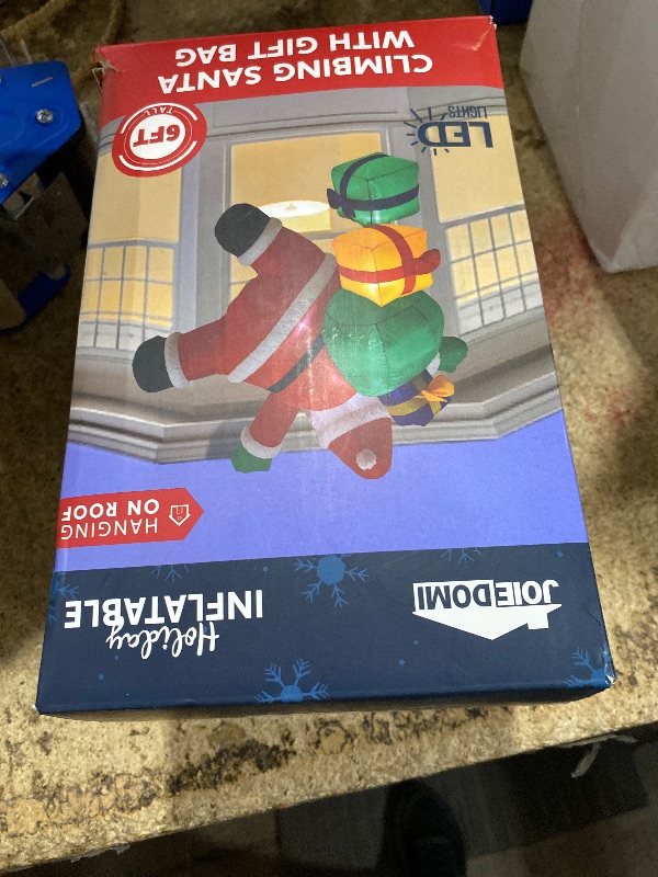 Photo 1 of **LIGHTS NON-FUNCTIONAL*** Joiedomi 6 FT Tall Christmas Inflatable Climbing Santa with Gift Bags, Blow Up Xmas Hanging Santa Outdoor Decorations with Build-in LEDs for Xmas Party Decor Yard Outside Garden Holiday Decorations