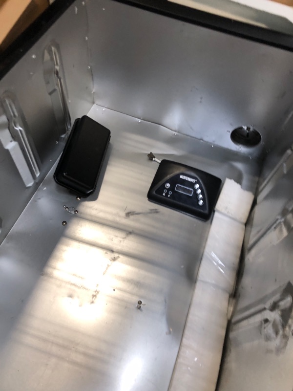 Photo 1 of ***HAS DENTS COMING OFF THE HNGES ***Masterbuilt® 40-inch Digital Electric Vertical BBQ Smoker with Leg Kit, Side Wood Chip Loader and 970 Cooking Square Inches in Black, Model MB20070122