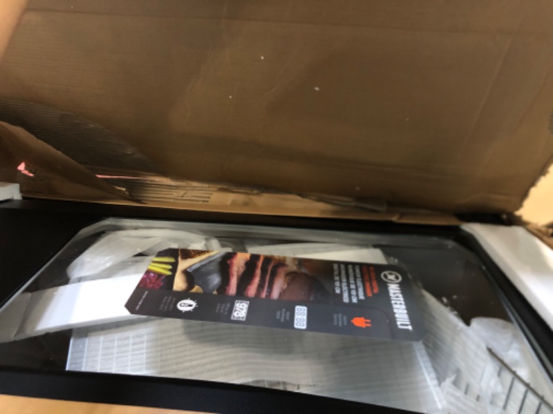 Photo 1 of ***HAS DENTS COMING OFF THE HNGES ***Masterbuilt® 40-inch Digital Electric Vertical BBQ Smoker with Leg Kit, Side Wood Chip Loader and 970 Cooking Square Inches in Black, Model MB20070122