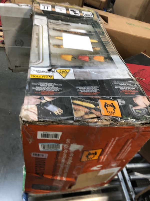 Photo 1 of ***HAS DENTS COMING OFF THE HNGES ***Masterbuilt® 40-inch Digital Electric Vertical BBQ Smoker with Leg Kit, Side Wood Chip Loader and 970 Cooking Square Inches in Black, Model MB20070122