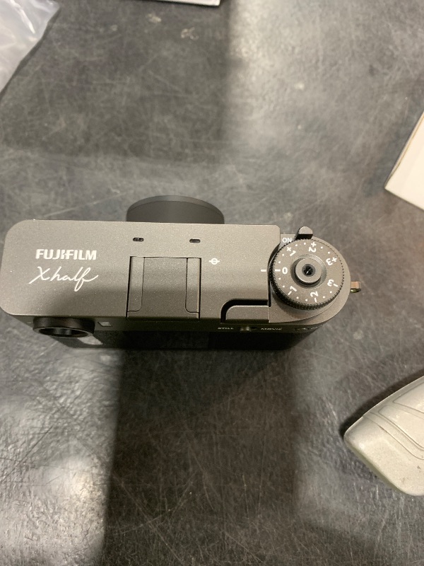 Photo 1 of FUJIFILM X Half Premium Compact Digital Camera (Charcoal Silver) Bundle with Carrying Case + 64GB Memory Card + Lens Cap Keeper + Memory Card Wallet + Hand Strap + More