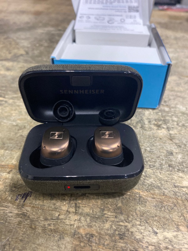 Photo 1 of **CHARGING PORT IS BROKEN** 
(WIRELESS CHARGING STATION DOES WORK)
Sennheiser Momentum True Wireless 4 Smart Earbuds with Bluetooth 5.4, Crystal-Clear Sound, Comfortable Design, 30-Hour Battery Life, Adaptive ANC, LE Audio and Auracast - Black Copper