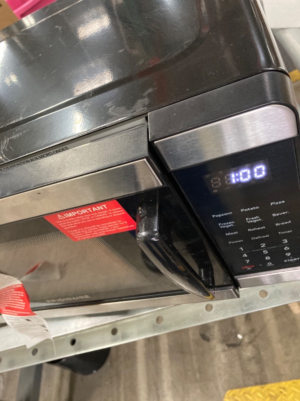 Photo 1 of ***DAMAGED -SELLING NON-FUNCTIONAL AS PARTS ONLY*** Frigidaire Countertop Microwave - Digital Control Panel - 6 Auto Cooking Settings - 10 Power Levels - Child Safety Lock - 0.7 Cu. Ft., Stainless Steel